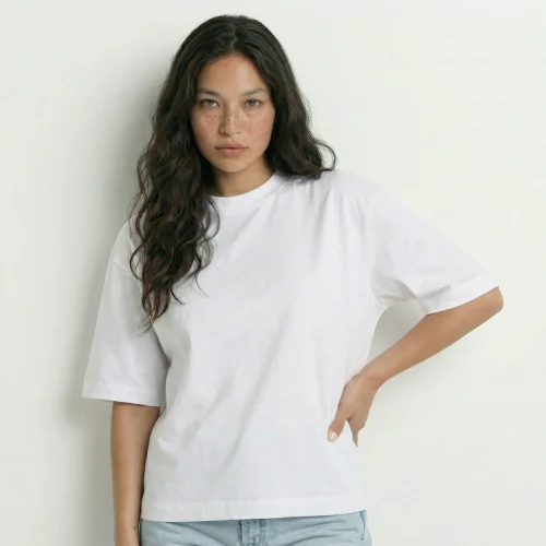 Mulher com cabelo castanho e t-shirt branca Over Boxy.