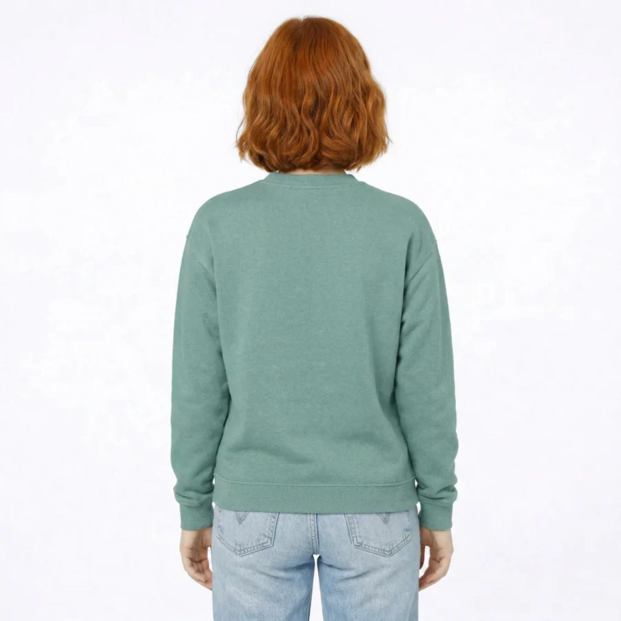 Woman from behind wearing a green sweatshirt and light-wash jeans.