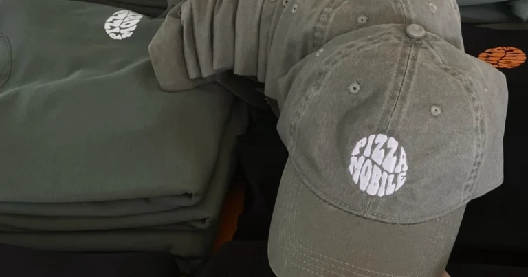 Custom hat and sweatshirts with "Pizza Mobile" logo for merchandising.